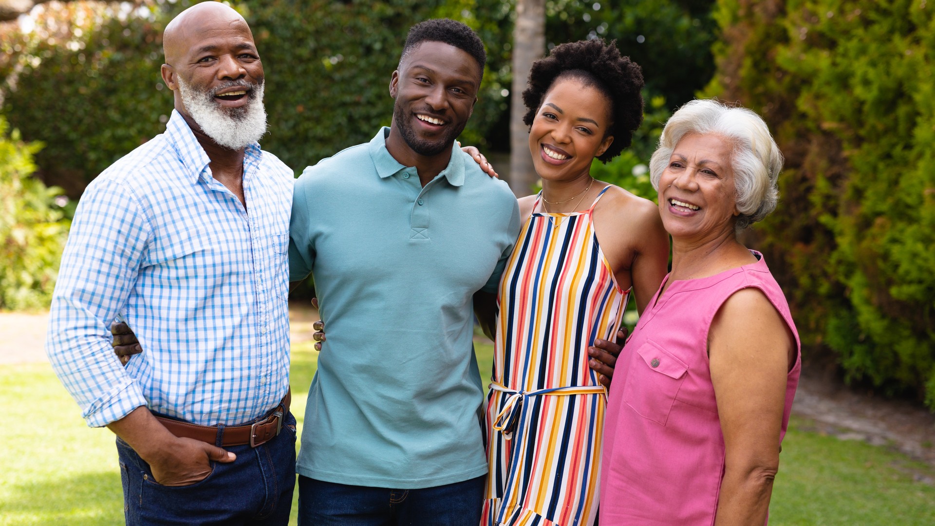 Family smiling together in their backyard