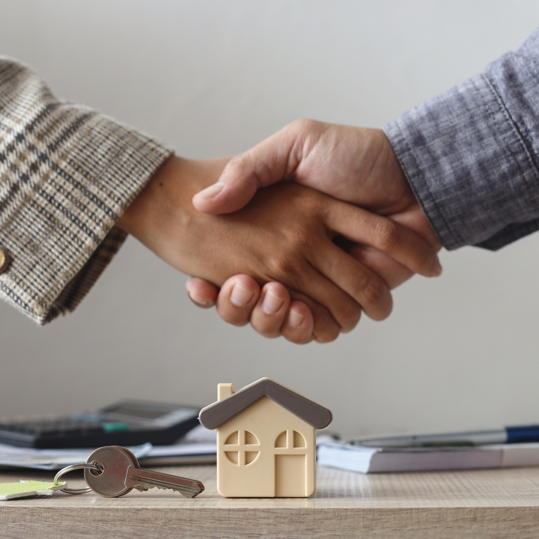 Closing attorney shaking hands across the closing table